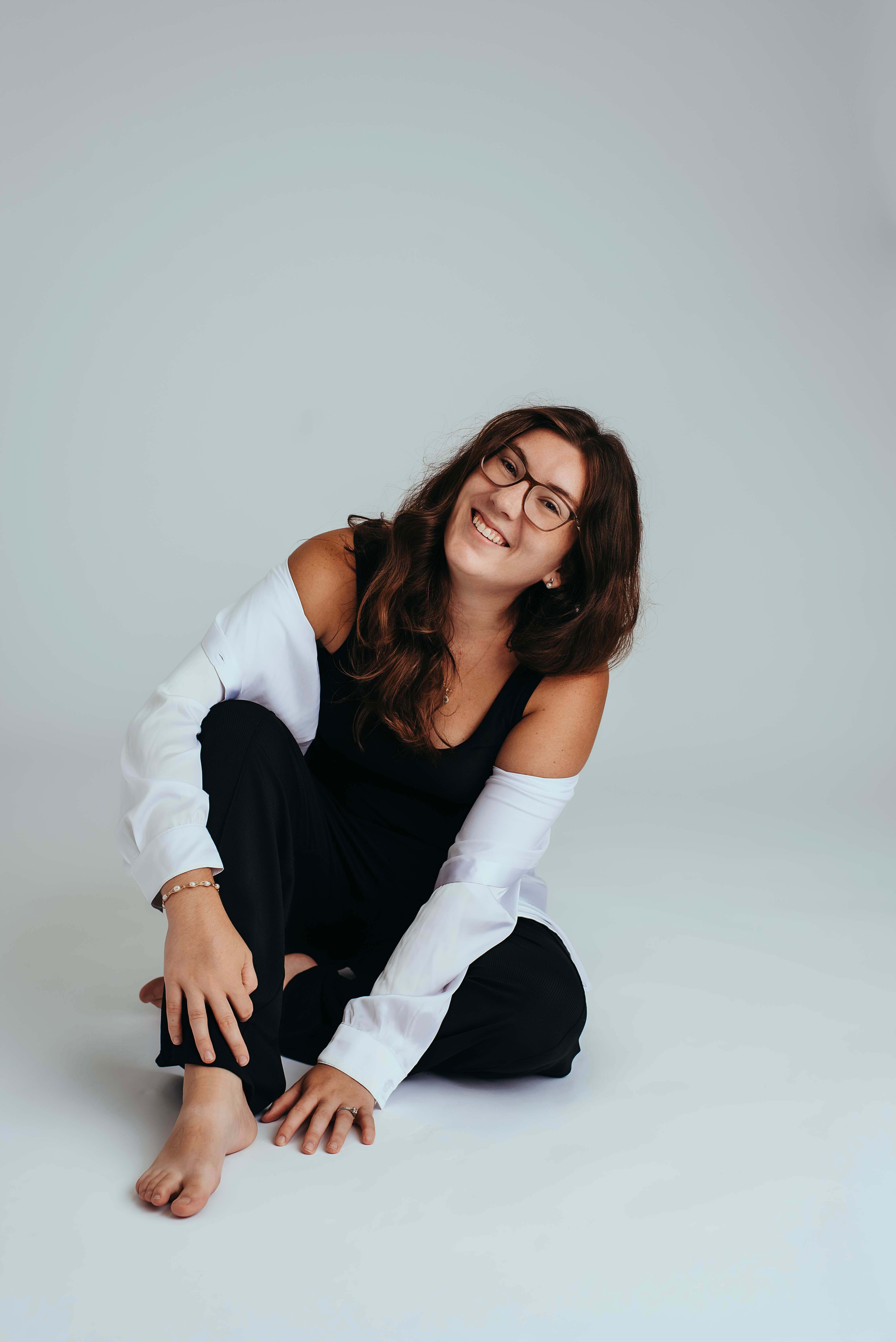 Branding photo of daphne, al newborn photographer, molly. She is wearing black pants, with a black shirt and a white over shirt